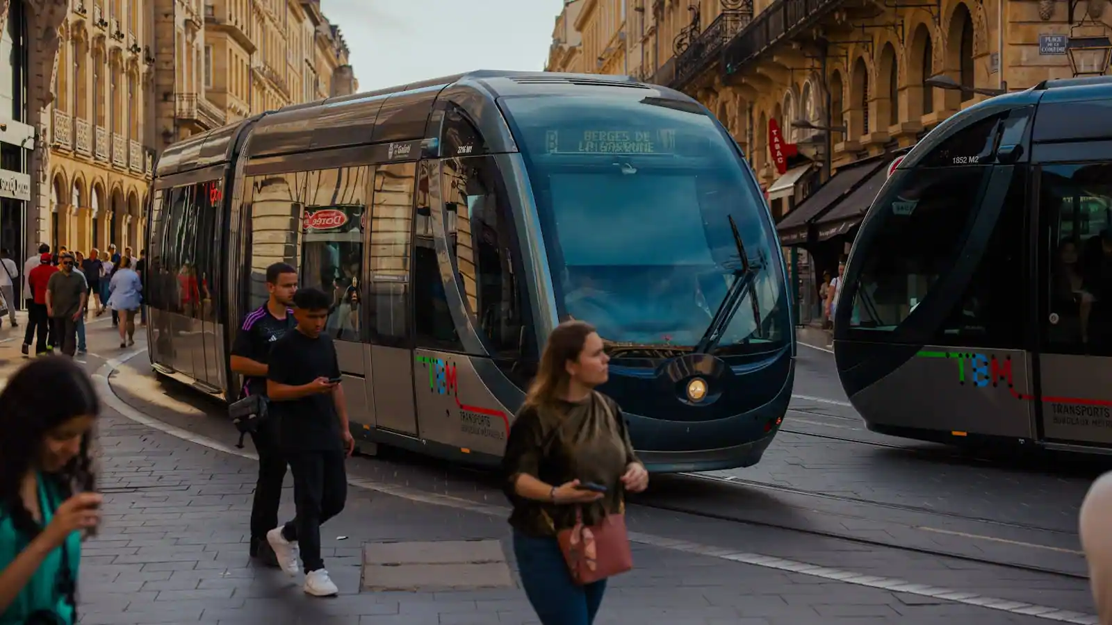 Immeuble haussmannien bordelais en pierre blonde au bord de la Garonne avec quais animés